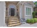 Inviting front entrance with a stone staircase and a cozy bench for relaxing at 4566 Fountain Ne Dr, Marietta, GA 30067