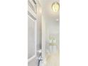 Bright entryway with hardwood floors leading to an open-concept living space and a neutral color scheme at 7630 Volion Pkwy, Fairburn, GA 30213