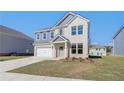 Charming two-story home featuring a two-car garage, manicured lawn, and inviting front porch at 107 St Annes Pl, Covington, GA 30016