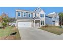 Inviting two-story home with a two-car garage, well-kept lawn, and lovely exterior design at 107 St Annes Pl, Covington, GA 30016