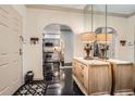 Inviting foyer with black floors, decorative mirror, and arched entrance to the kitchen at 2499 Peachtree Ne Rd # 108, Atlanta, GA 30305