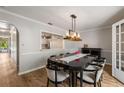 Formal dining room featuring modern lighting and a view into the kitchen at 1140 Moorestown Cir, Decatur, GA 30033