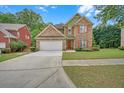 Attractive two-story home with brick and siding, featuring a driveway and well-maintained lawn at 1990 Cooper Lakes Dr, Grayson, GA 30017