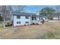 Spacious two-story home with a covered carport, featuring a well-kept lawn and inviting front porch at 2885 Green Rd, Loganville, GA 30052