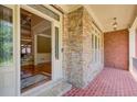 Inviting foyer with brick flooring and stone accent wall, leading to hardwood floors at 737 Heritage Post Ln, Grayson, GA 30017