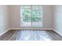 Inviting bedroom with a large window, wood floors, and ample natural light at 340 Onyx Ct, Atlanta, GA 30349