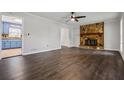 Spacious living room with hardwood floors, a stone fireplace, and ample natural light at 3664 Nessa Se Ct, Smyrna, GA 30082