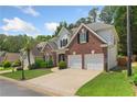 Beautiful two-story home with brick accents, a lush green lawn, and an attached two-car garage at 4018 Rhyne Se Cir, Smyrna, GA 30082