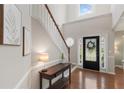 Bright foyer with hardwood floors, a staircase, and a decorative front door with sidelights at 4018 Rhyne Se Cir, Smyrna, GA 30082