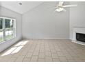 Airy living room with fireplace and large bright window at 5480 Walnut Ln, Lithonia, GA 30038