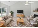Cozy living room with large window, fireplace and ceiling fan at 5480 Walnut Ln, Lithonia, GA 30038