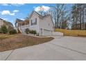 Exterior view of home featuring a two car garage, spacious driveway, and fenced yard at 954 Josie Ct, Lawrenceville, GA 30045