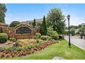 Welcoming community entrance with beautiful landscaping at The Views at Lenox Crossing at 2252 Limehurst Ne Dr, Atlanta, GA 30319