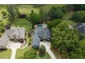 An aerial view of a luxurious home with a backyard pool and beautifully landscaped grounds at 5860 Stoneleigh Dr, Suwanee, GA 30024