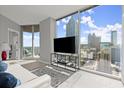Bright living room with large windows showcasing city views, modern furnishings, and neutral tones at 400 W Peachtree Nw St # 3611, Atlanta, GA 30308