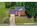 Beautiful aerial view of a two-story brick home showcasing the manicured lawn and mature trees at 1370 Stoney Field Place, Lawrenceville, GA 30043