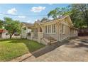 Well-maintained home featuring a brick facade, a covered porch and driveway at 1667 Sylvan Sw Rd, Atlanta, GA 30310
