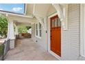 Welcoming front porch with sitting area and brick facade leading to front door at 1667 Sylvan Sw Rd, Atlanta, GA 30310