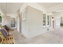 Covered porch featuring a charming swing, brick walls and neutral color palette at 1667 Sylvan Sw Rd, Atlanta, GA 30310