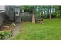 Backyard with wooden steps leading up to a wooden back porch with wooded view at 2859 Wood Park Nw Trce, Kennesaw, GA 30152