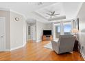 Spacious living room with hardwood flooring, tray ceiling, and modern furniture at 325 E Paces Ferry Rd # 2003, Atlanta, GA 30305