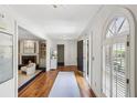 Inviting foyer with hardwood floors, large window, and view into the living room at 5270 Forest Brook Pkwy, Marietta, GA 30068