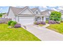 Single-story gray home with a manicured lawn, an attached garage, and lovely landscaping at 101 Wins Walk, Cartersville, GA 30121