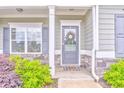Inviting front porch with stone accents, a decorative wreath, and a stylish exterior at 101 Wins Walk, Cartersville, GA 30121