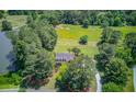Aerial view of the property showing the house, a large backyard, and bordering trees and landscaping at 1292 Green Turf Dr, Snellville, GA 30078