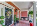 Inviting front porch with a swing, brick flooring, and decorative plants, leading to the home's entrance at 1292 Green Turf Dr, Snellville, GA 30078