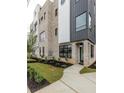 Modern home displaying clean lines, gray brick, black window frames, and lush landscaping at 1962 8Th St, Chamblee, GA 30341