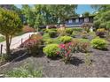 Beautiful two-story home with a well-landscaped front yard featuring colorful flowers, trees, and shrubbery at 2139 Cedarbrook Court South East, Atlanta, GA 30316