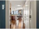Hallway view leads to a modern living space, bathed in natural light with sleek hardwood floors at 270 17Th Nw St # 1113, Atlanta, GA 30363