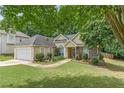 Attractive home featuring landscaped yard, stone accents, and an attached two-car garage at 1335 Vine Cir, Mcdonough, GA 30253