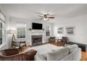 Bright living room with fireplace, plush seating, large windows, and hardwood floors at 174 Crumley St, Atlanta, GA 30312