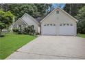 Charming home highlighting a manicured lawn, brick accents, and a two-car garage at 3001 Garland Sw Dr, Marietta, GA 30008