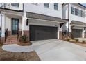 Attractive townhouse exterior with brick accents, a two-car garage, and well-manicured landscaping for great curb appeal at 711 Dodd N Ln # 166, Buford, GA 30518