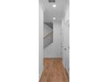 Long hallway with hardwood floors and a staircase with black iron railings at 711 Dodd N Ln # 166, Buford, GA 30518