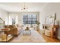 Bright living room features hardwood floors, large windows, and stylish decor for a welcoming atmosphere at 1199 Huff Nw Rd # 127, Atlanta, GA 30318
