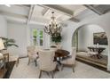 Elegant dining room featuring coffered ceilings and a stylish chandelier at 95 Grogans Lndg, Atlanta, GA 30350