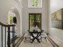 Bright foyer featuring travertine tile flooring, arched doorways and a decorative table at 95 Grogans Lndg, Atlanta, GA 30350