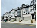 A street view of new townhomes with a modern design featuring garages and well-manicured landscaping at 1320 Stanley Park Dr # 141, Decatur, GA 30033