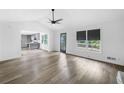 Bright open-concept living room with a kitchen view and access to an outdoor patio at 4205 Mabry Ne Rd, Roswell, GA 30075