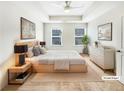 Serene main bedroom boasting a tray ceiling, plush carpet, and ample natural light at 4922 Longview Walk, Decatur, GA 30035