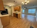 The kitchen and living area features new hardwood floors, neutral paint, and stainless steel appliances at 143 Ilex Dr, Canton, GA 30114