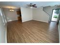 Open-concept living area with hardwood floors leading to the staircase and front door at 143 Ilex Dr, Canton, GA 30114