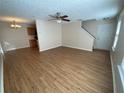 Spacious living area with hardwood floors and a staircase leading upstairs at 143 Ilex Dr, Canton, GA 30114