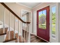 Foyer featuring hardwood floors, staircase, and a red front door with sidelights at 4379 Bonaparte Dr, Tucker, GA 30084