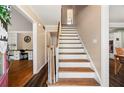 Bright foyer featuring hardwood floors, staircase with white risers, and views of adjacent rooms at 4379 Bonaparte Dr, Tucker, GA 30084
