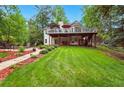 Expansive backyard featuring a well-maintained lawn, patio area, and lush greenery, perfect for outdoor living at 827 Pinehurst Dr, Woodstock, GA 30188